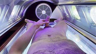 hot guy shows his dick in a tanning bed